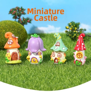Close-up of four colorful miniature resin fairy castles on grass for micro landscapes