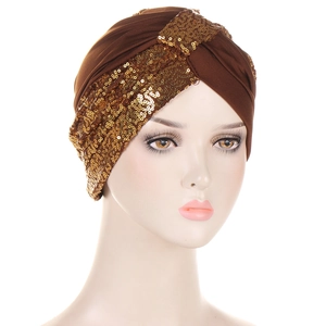 Detail shot of shimmering gold sequins on a dark brown turban hat for women
