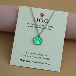 Glow-in-the-dark paw pendant with stainless steel chain on a gift message card