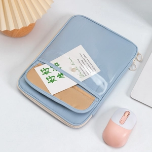 Detail of blue canvas tablet sleeve with transparent PVC pocket and snap closure