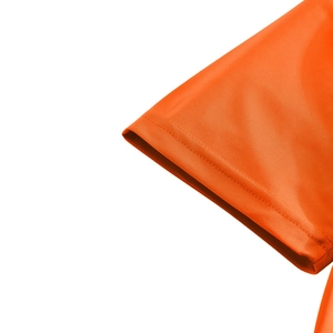 Close-up of bright orange polo shirt sleeve showing breathable mesh fabric and neat stitching