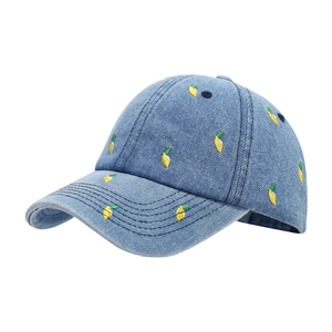 Blue denim baseball cap with yellow lemon embroidery pattern in a side-view pose