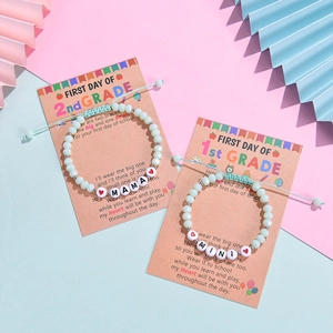 Matching mint green beaded MAMA and MINI bracelets set with back card on a pastel background