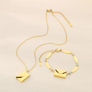 Dettaglio della collana a busta dorata e bracciale in cristallo in acciaio inox