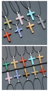Macro shot of 40mm cross pendants in tiger eye, lapis lazuli and natural crystals