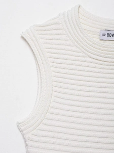 Detail shot of white ribbed knit fabric texture and neckline on sleeveless dress
