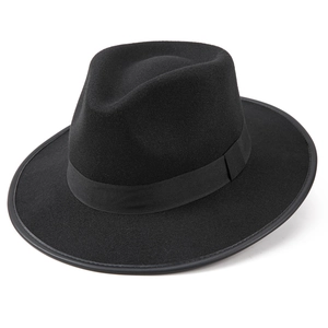 Detail of classic black wool felt fedora featuring matching ribbon band on white background