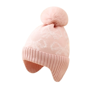 Pink winter knitted earflap hat for girls featuring a large pompom and jacquard bow pattern