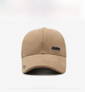 Detail of embroidered letters on warm khaki cotton baseball cap with reinforced stitching