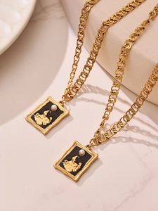 Detail of 18k gold plated double layer necklace with black square relief pendant