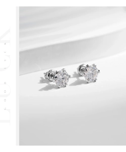 Macro view of 925 sterling silver crown-shaped earrings with round moissanite in six-prong setting