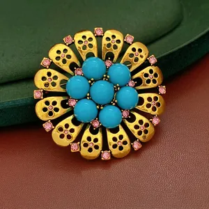 Vintage gold hollow flower brooch with turquoise beads and pink rhinestones detail