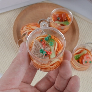 Miniature beef noodle keychain with transparent bucket housing and realistic food models
