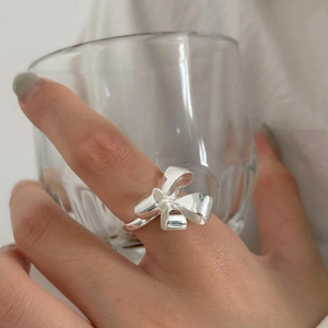 Minimalist S925 sterling silver bow knot ring on finger with high polish finish