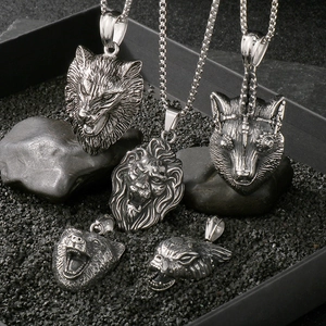 Vintage punk silver animal pendants including lion and wolf heads on black gravel