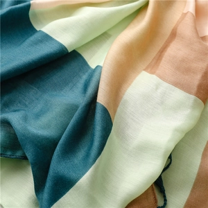 Detailed macro view showing the textured cotton linen fabric and pastel geometric color blocks