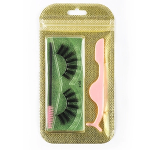 Detailed set featuring thick black false eyelashes with pink tweezers and brush in gold bag