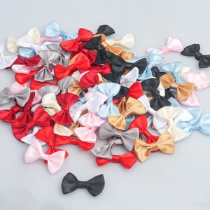 Macro shot of colorful mini satin ribbon bows for DIY crafts and gift packaging