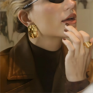 Golden hammered texture square earrings and matching ring set worn by model
