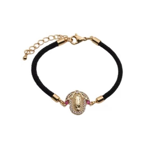 Detailed shot of Virgin Mary charm on black woven bracelet with colorful zircon stones