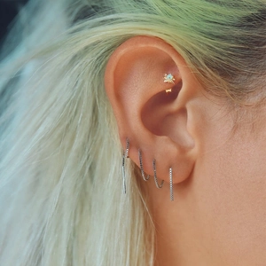 Close-up of S925 sterling silver chain earrings with heart and geometric tassels on model