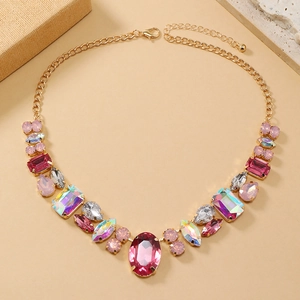 Detail of colorful oval and pear cut crystals on a gold-plated link necklace