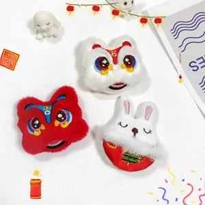 Detailed plush brooches featuring traditional Chinese lion dance and New Year rabbit designs
