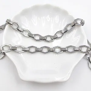 Stainless steel chain bracelet featuring hexagonal links and Greek key pattern engraving