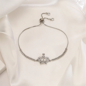 Detailed view of crown pendant bracelet with zircon stones and adjustable sliding clasp