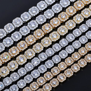 Macro view of gold and silver iced-out tennis chains with square links and clear zircons