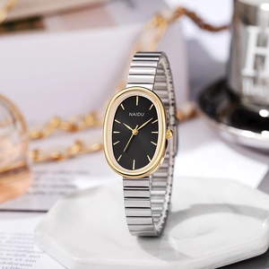 Detail of NAIDU silver stretch band watch with oval gold case and black dial face