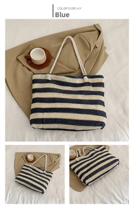 Close-up of blue striped straw tote bag showing woven texture and rope handles