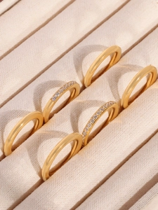 Detailed macro view of 18K gold plated stainless steel rings with 5A zircon stones in box