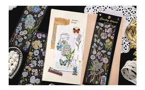 Macro detail of PET stickers with gold foil floral and butterfly motifs on dark background