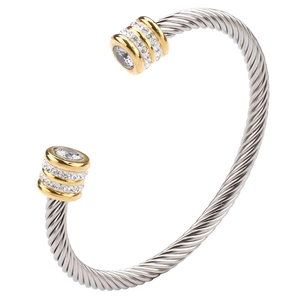 Close-up of dual-tone cable twist bangle with crystal pave and gold-plated end caps