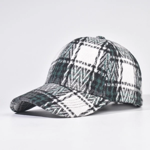 Detail view of thickened plaid baseball cap showing green and white tweed texture
