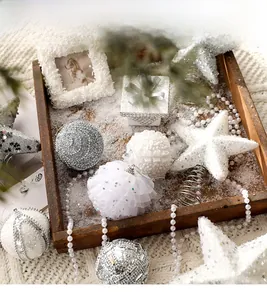 Detailed set of silver and white textured Christmas ornaments with star tree topper