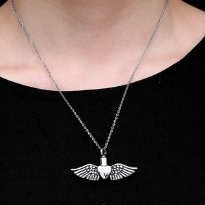 Silver stainless steel heart urn necklace with wings shown on a model's neck