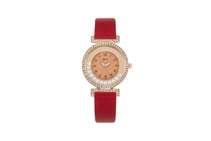 Detailed macro view of sparkling diamonds on rose gold case with red leather strap