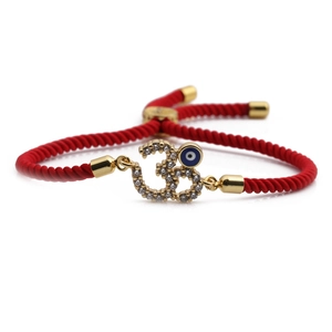 Adjustable red rope bracelet with golden 3D Evil Eye and Om symbol in blue zircon