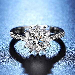 Macro shot of silver flower cluster ring with brilliant cut center stone and halo details