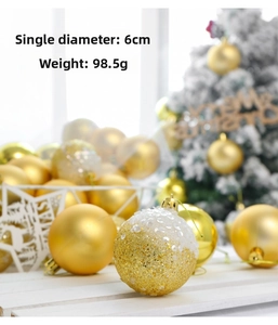 Close-up of 6cm golden Christmas balls with glitter and matte finish on white wood