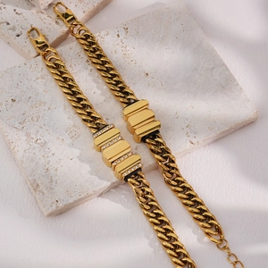 Mens gold stainless steel Cuban chain bracelet set with rhinestone accents on stone
