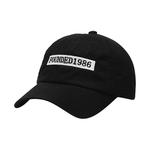 Classic black cotton baseball cap with vintage 1986 embroidery on a white patch