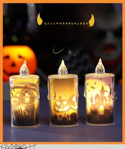 Three LED Halloween candles with reaper, pumpkin, and castle graphics in warm glow