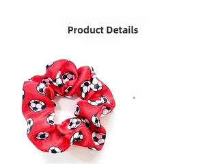Detailed close-up of a red satin football pattern scrunchie with elastic fabric texture