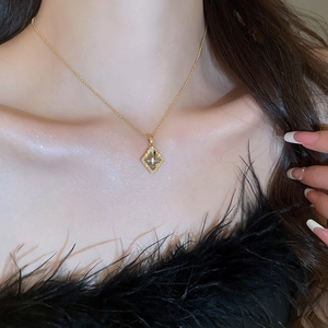 Close-up of a vintage gold-plated diamond flower necklace on a model's neck