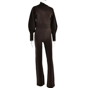 Detail view of brown knit two-piece set featuring button collar and ribbed sleeve cuffs