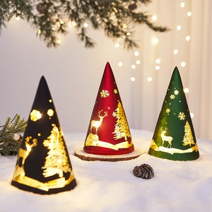 Three conical Christmas LED glass lamps with elk and snowflake patterns on snow