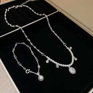 Elegant zircon pearl flower pendant necklace and bracelet set in a black jewelry box